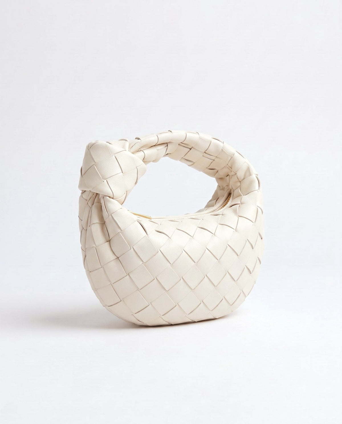 Knot Mini woven leather bag in Chalk – three-quarter view