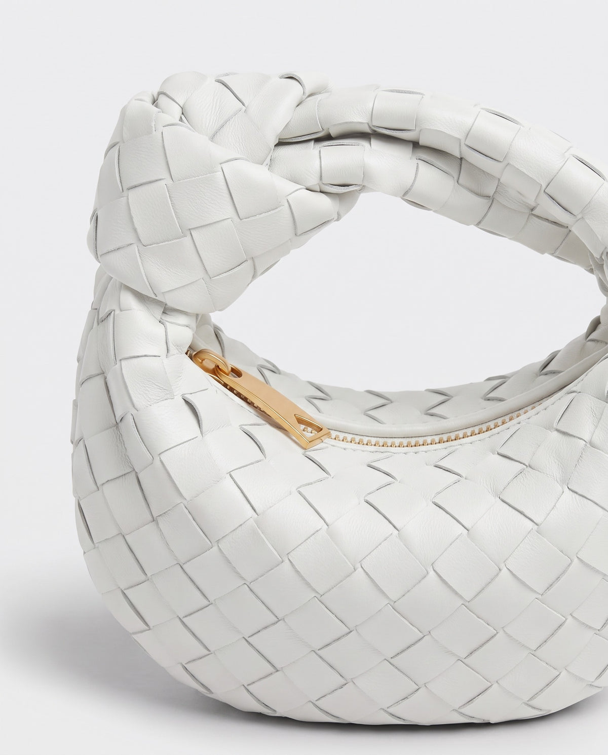 Knot Mini woven leather bag in Chalk – close-up of the knotted handle