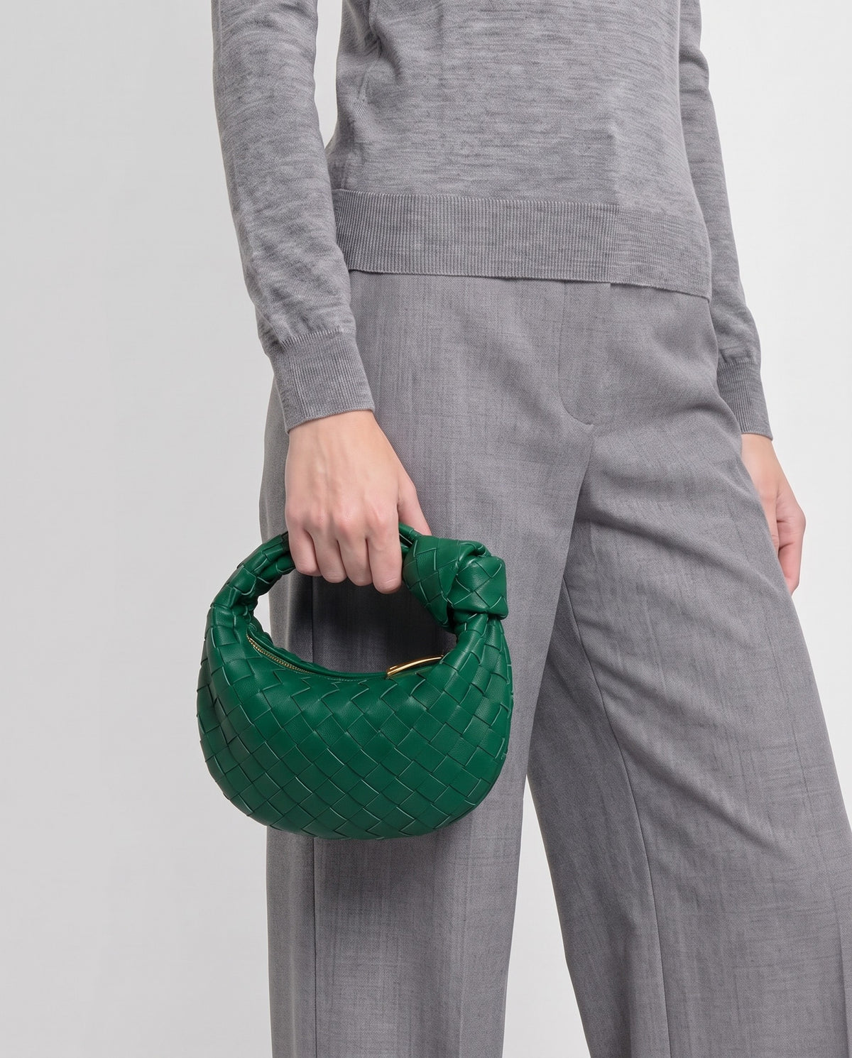 Knot Mini woven leather bag in Emerald – model carrying it