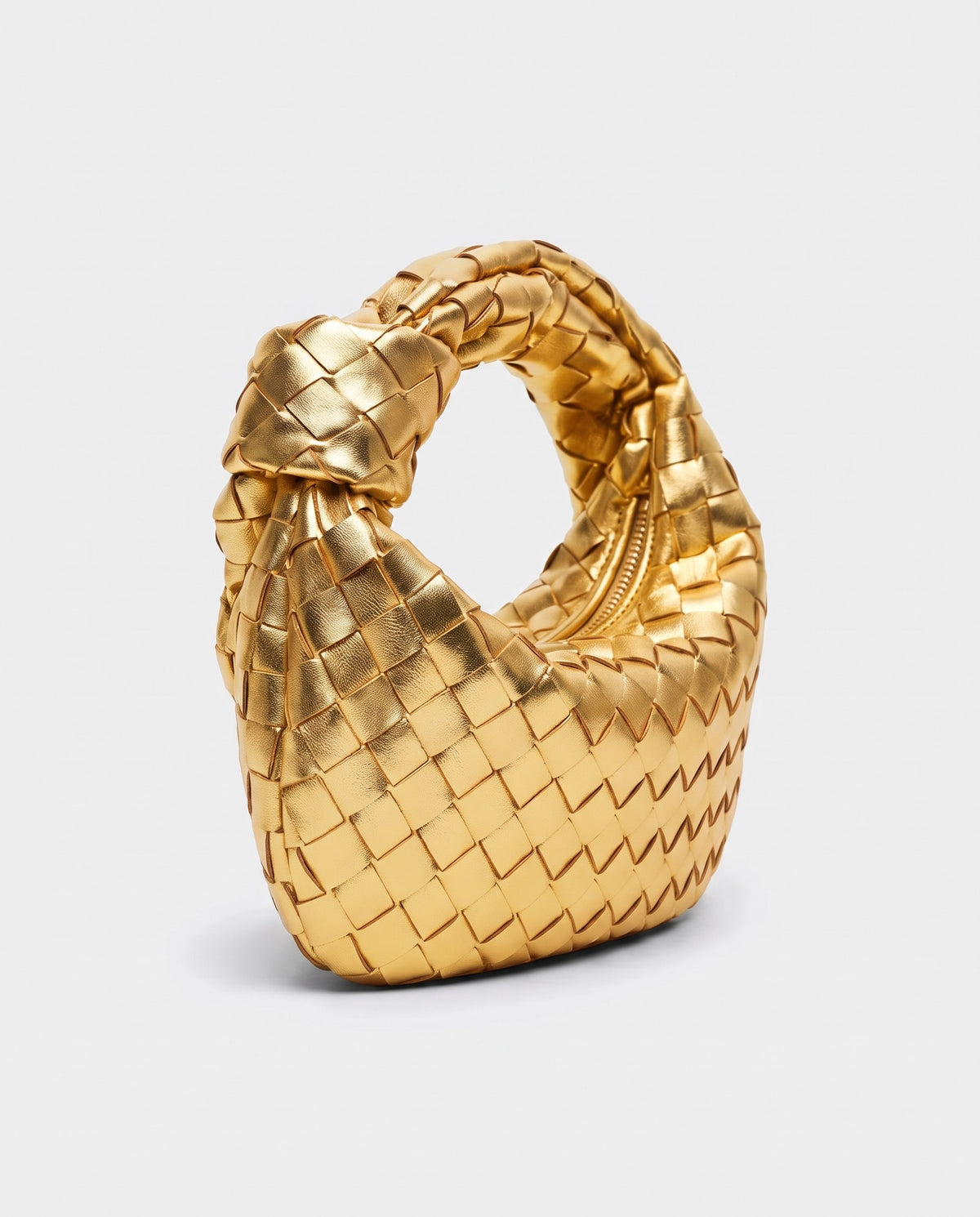 Knot Mini woven leather bag in Gold – three-quarter view