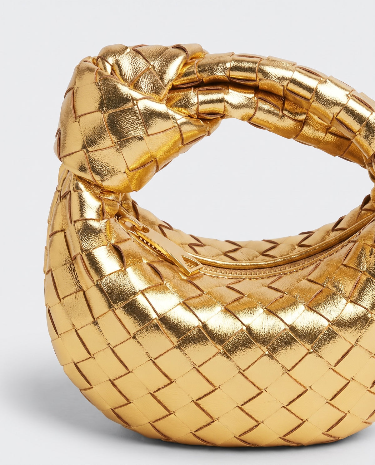 Knot Mini woven leather bag in Gold – close-up of the knotted handle