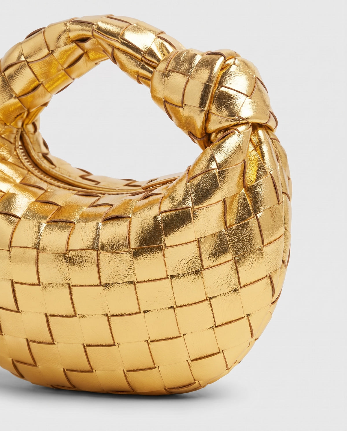 Knot Mini woven leather bag in Gold – close-up of the woven leather
