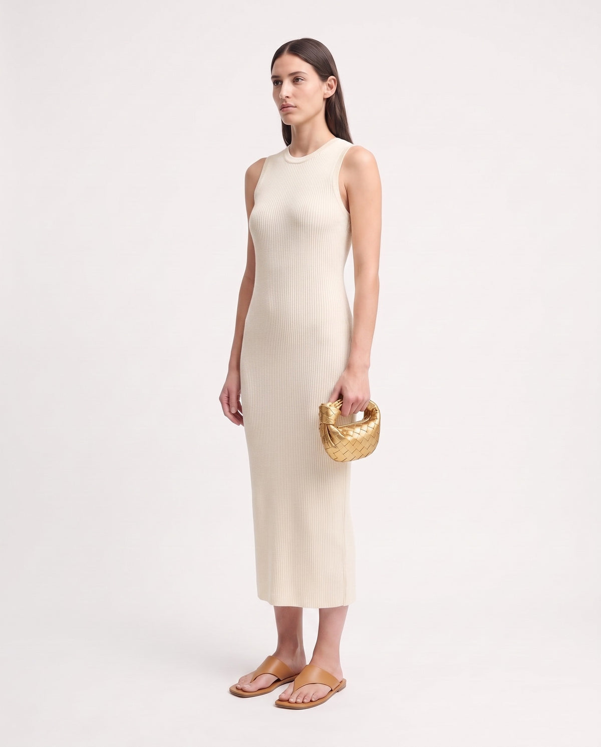 Knot Mini woven leather bag in Gold – model holding it, full length
