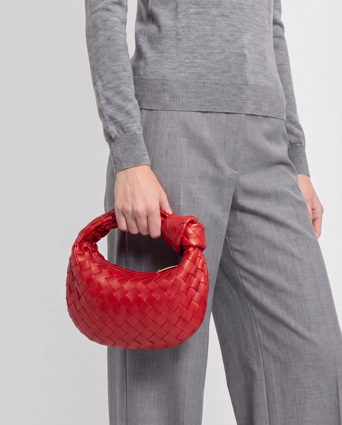 Knot Mini woven leather bag in Scarlet – model carrying it