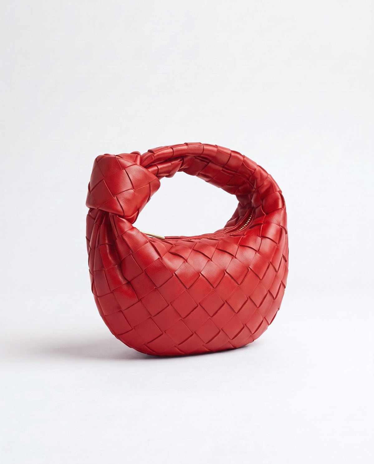 Knot Mini woven leather bag in Scarlet – three-quarter view