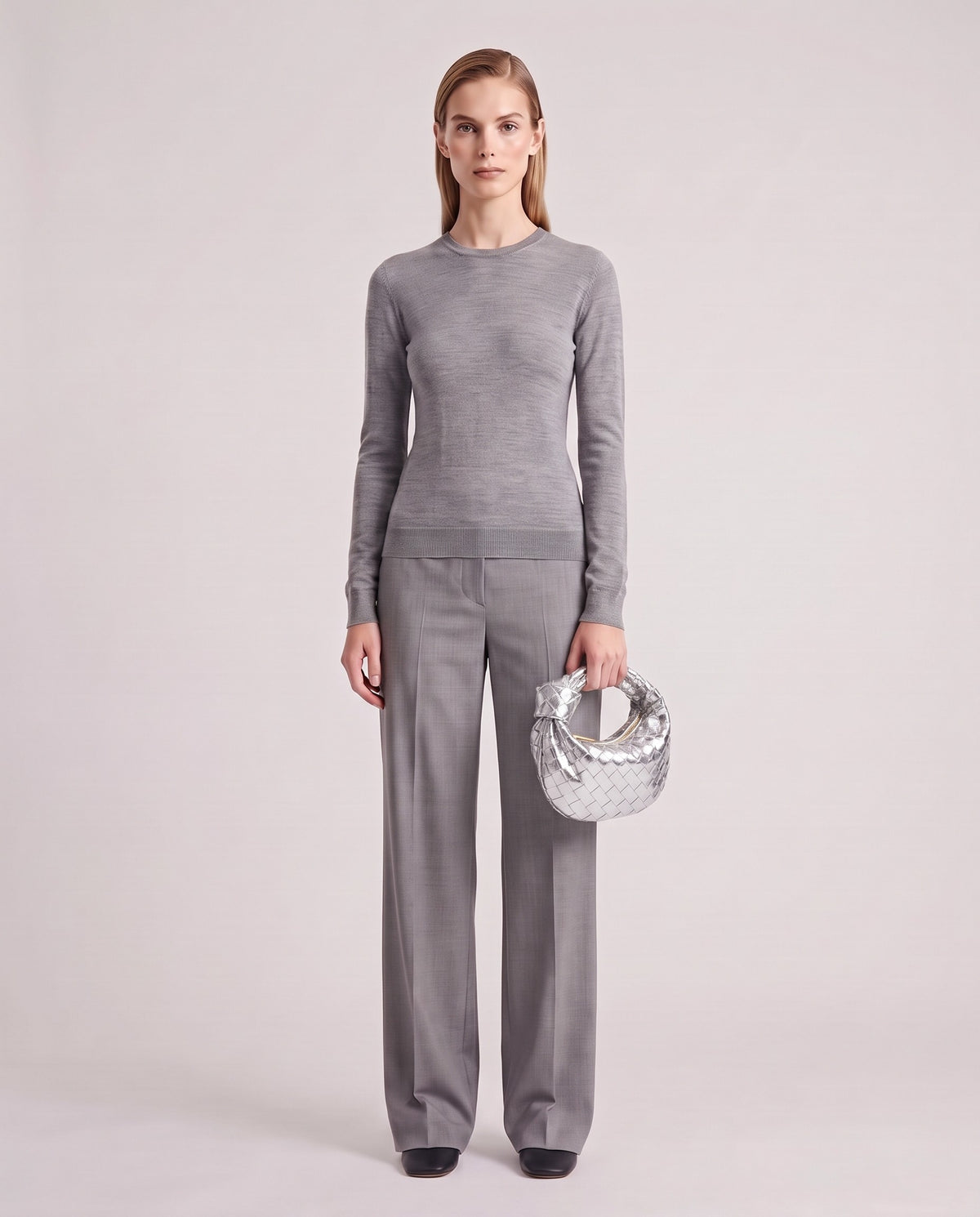 Knot Mini woven leather bag in Silver – model holding it, full length