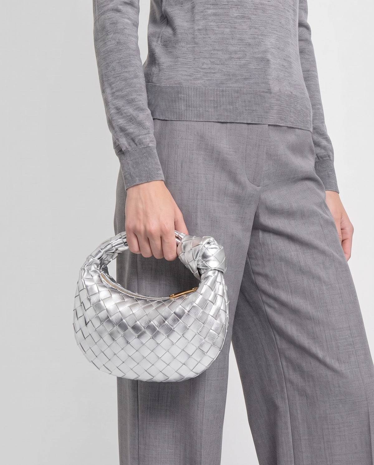 Knot Mini woven leather bag in Silver – model carrying it