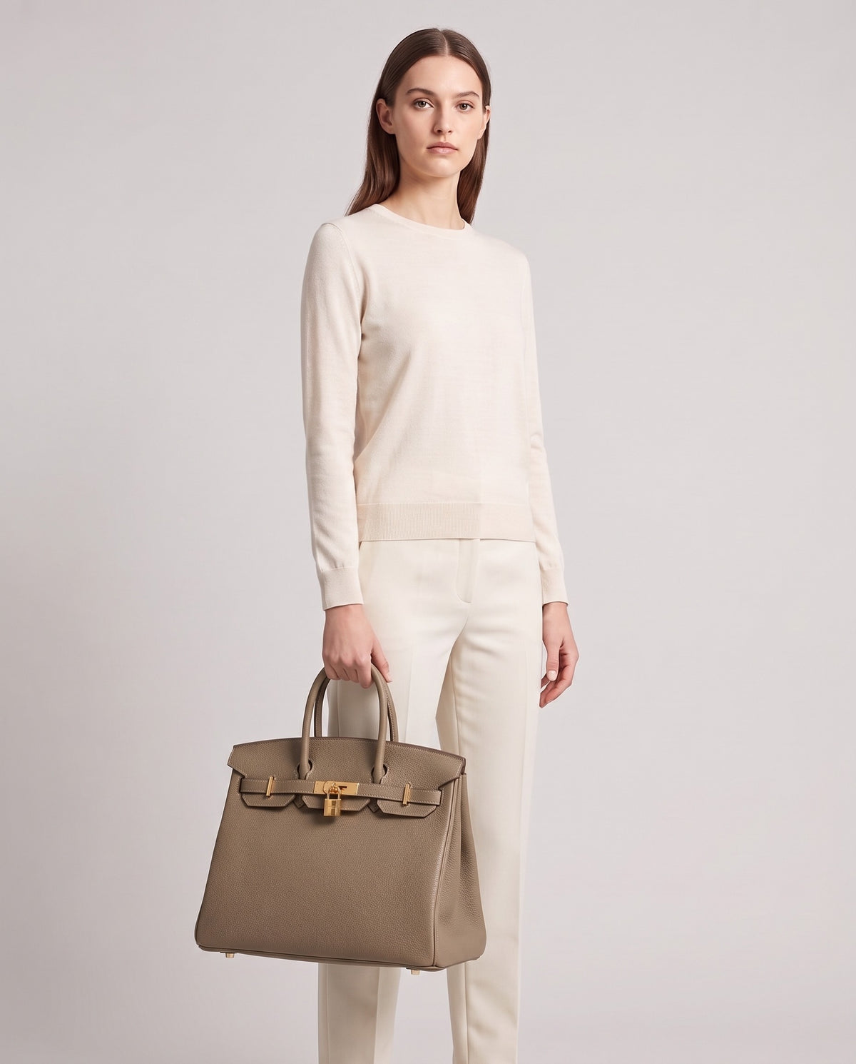 Lock Extra Large leather top-handle bag in Taupe – model holding it, full length