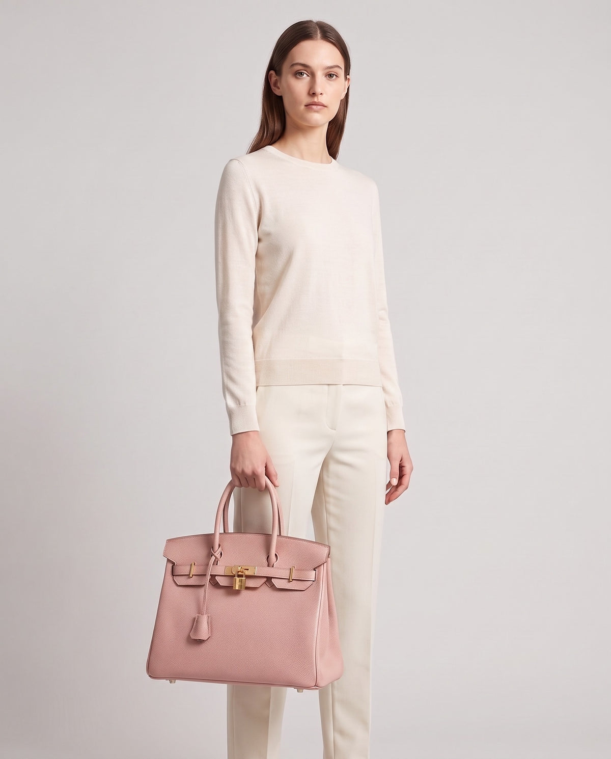 Lock Large leather top-handle bag in Blush – model holding it, full length