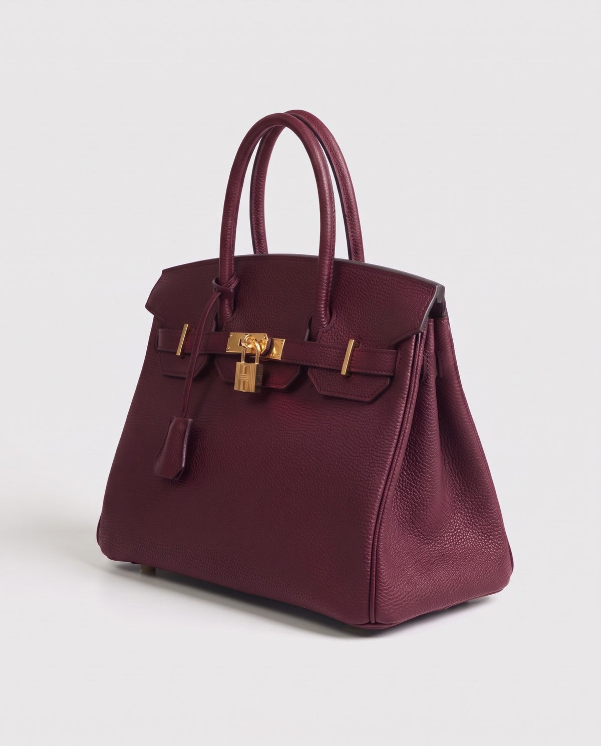 Lock Medium leather top-handle bag in Bordeaux – three-quarter view