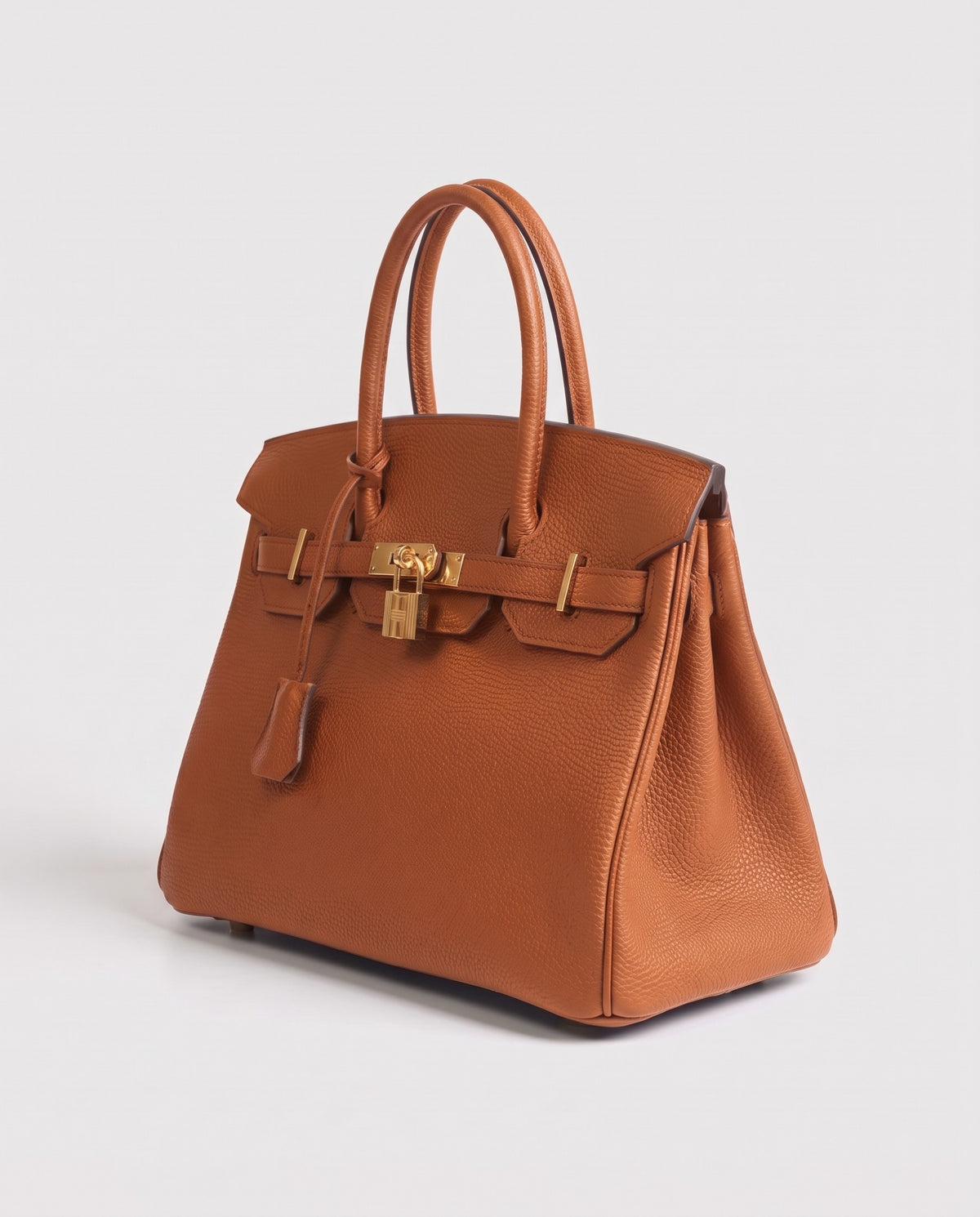 Lock Small leather top-handle bag in Caramel – three-quarter view