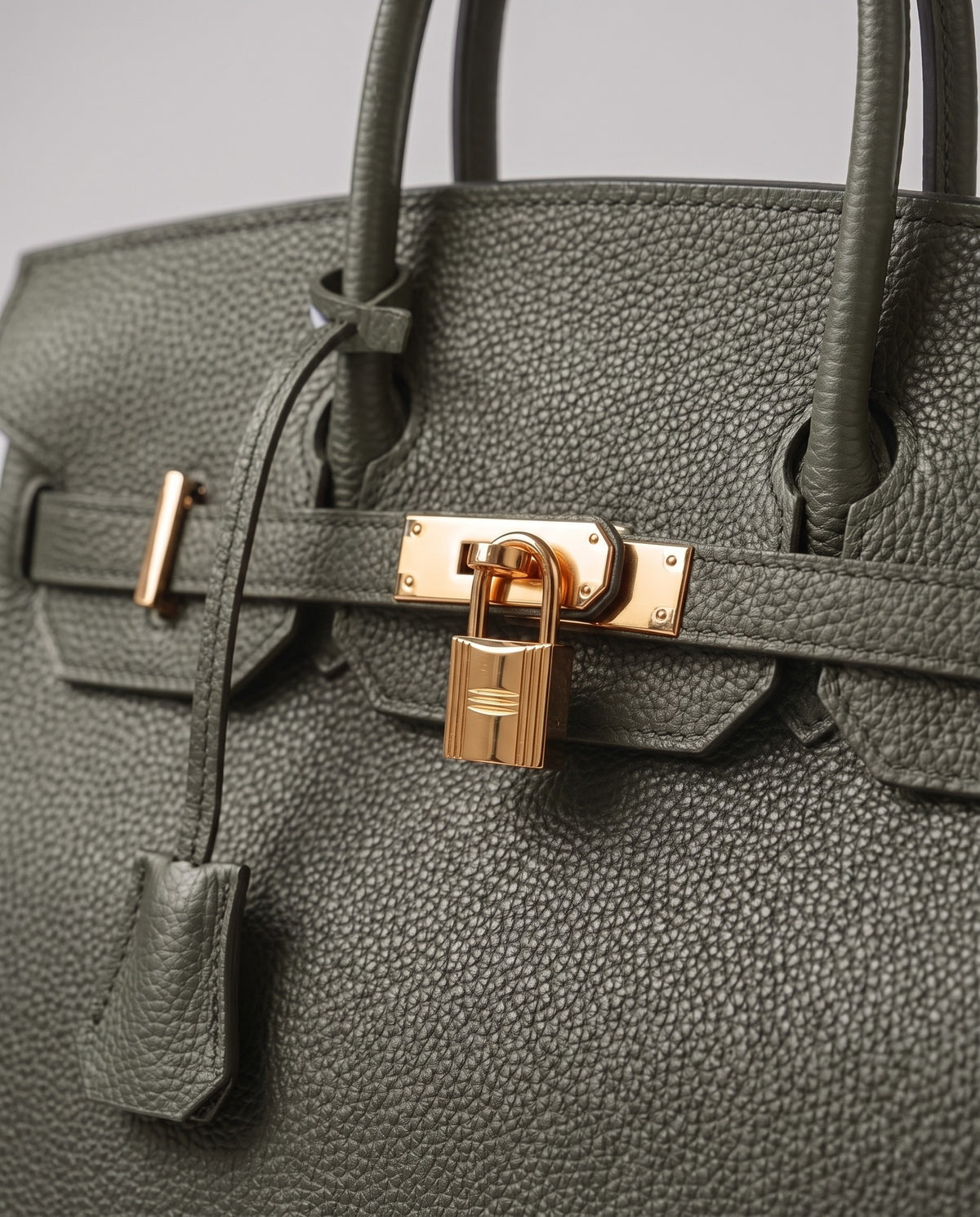 Lock Small leather top-handle bag in Celadon – close-up of the gold turn-lock and padlock