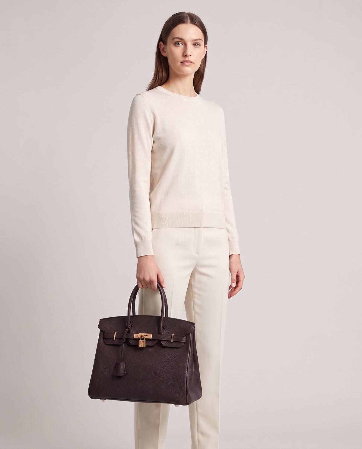 Lock Small leather top-handle bag in Espresso – model holding it, full length