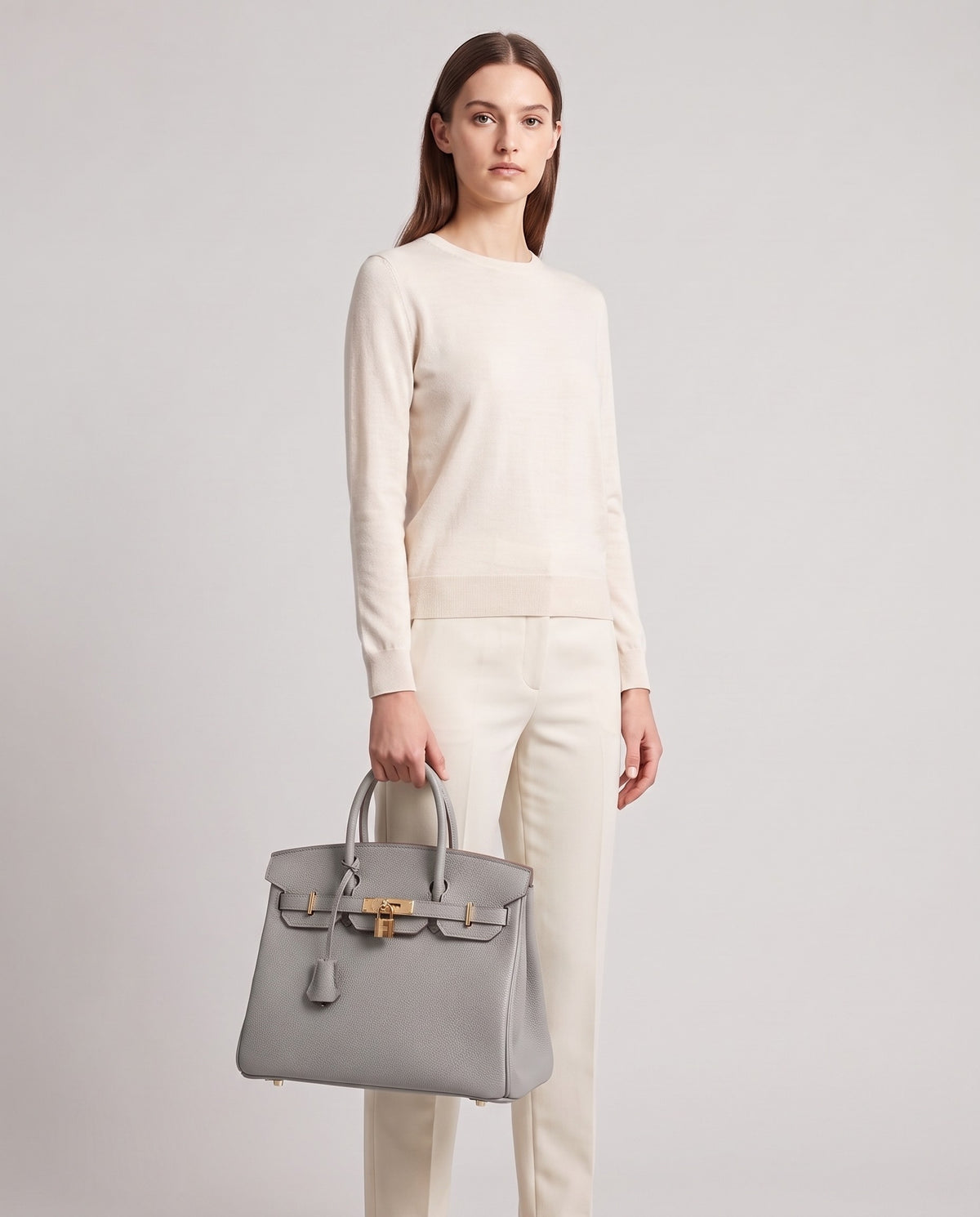 Lock Small leather top-handle bag in Grey – model holding it, full length