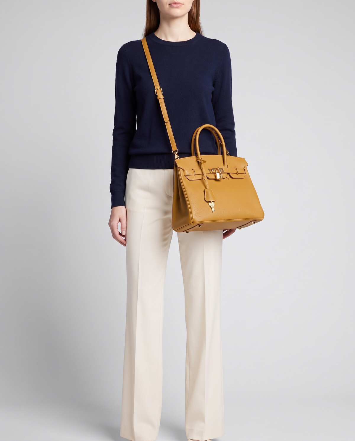 Lock Small leather top-handle bag in Mustard – model wearing it crossbody on the detachable shoulder strap