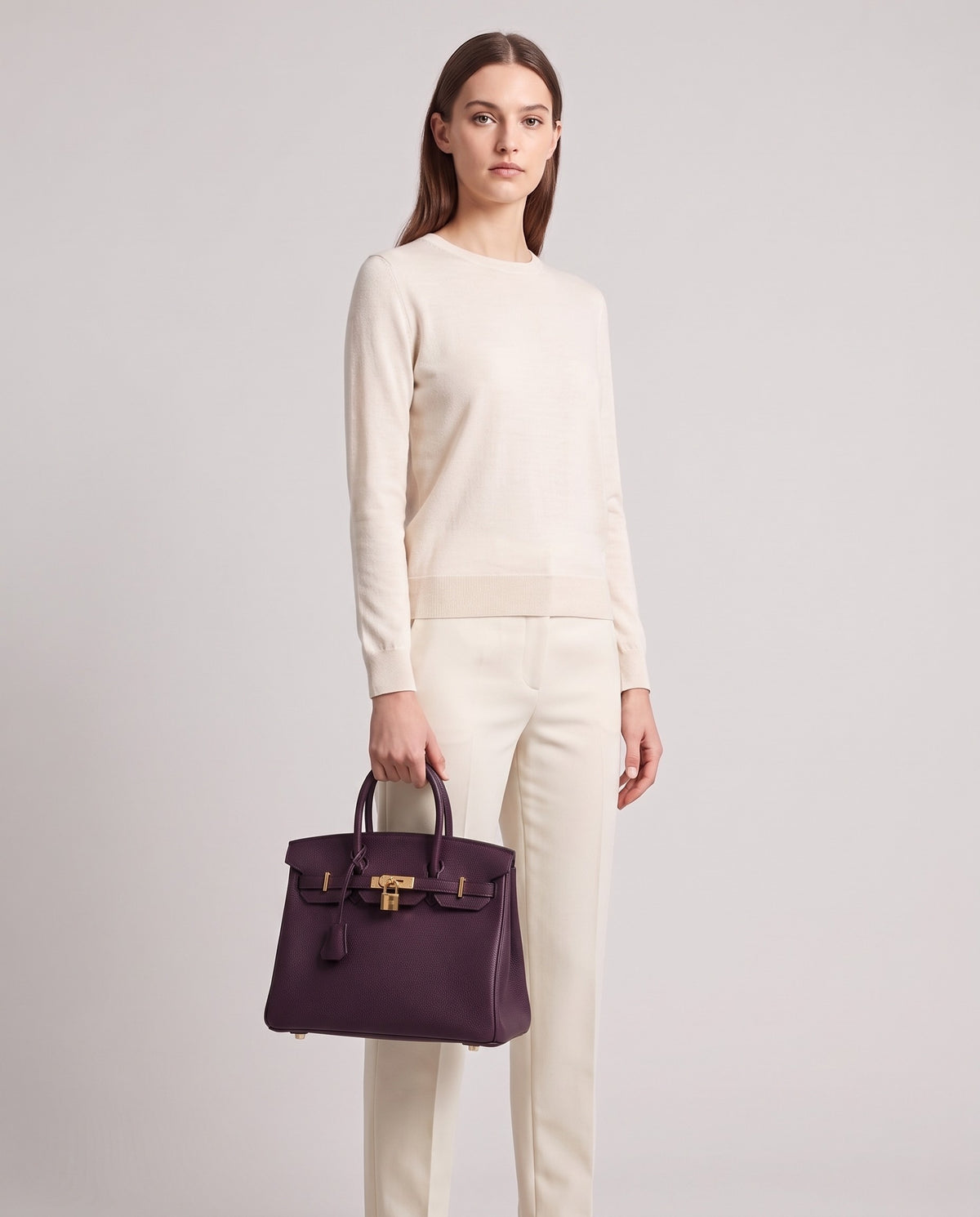 Lock Small leather top-handle bag in Purple – model holding it, full length