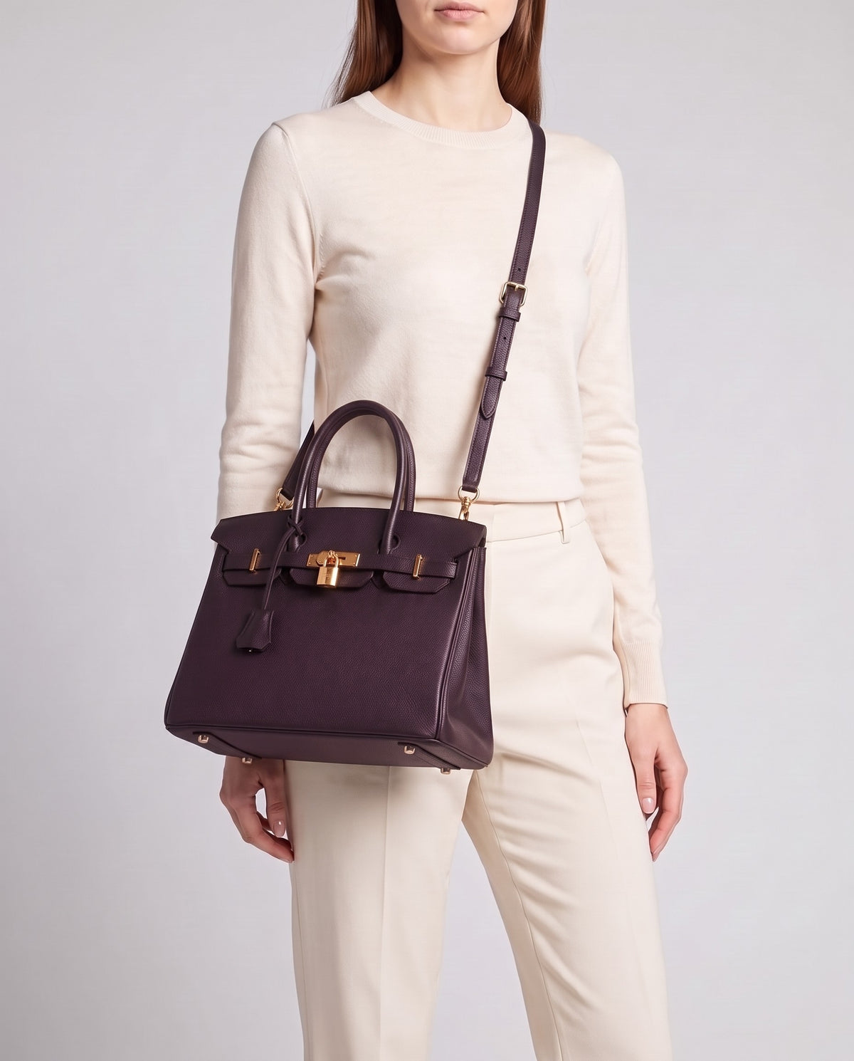 Lock Small leather top-handle bag in Purple – model wearing it crossbody on the detachable shoulder strap