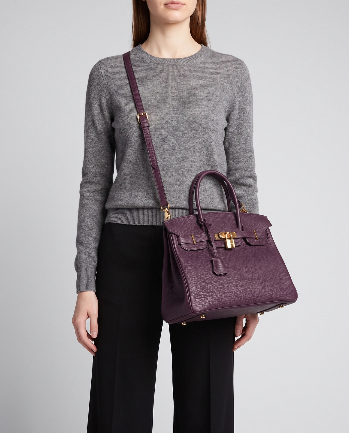 Lock Small leather top-handle bag in Purple – model wearing it crossbody on the detachable shoulder strap