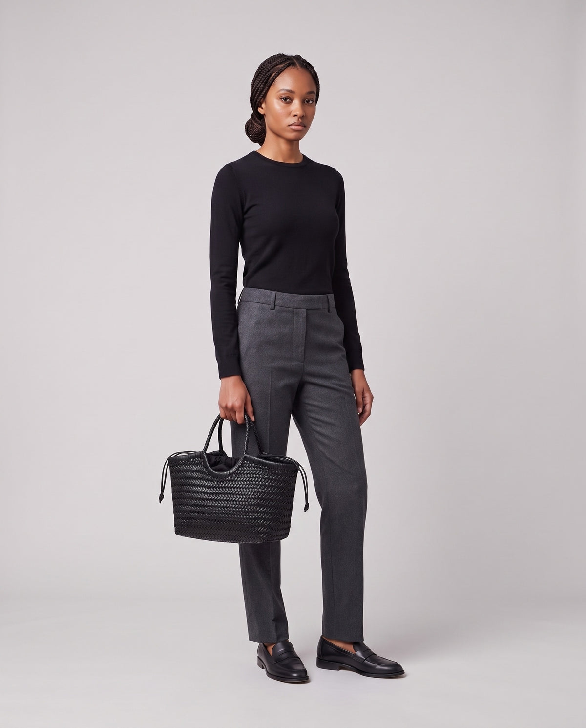 Model holding the Valentina Matera Large bag in Black, full length