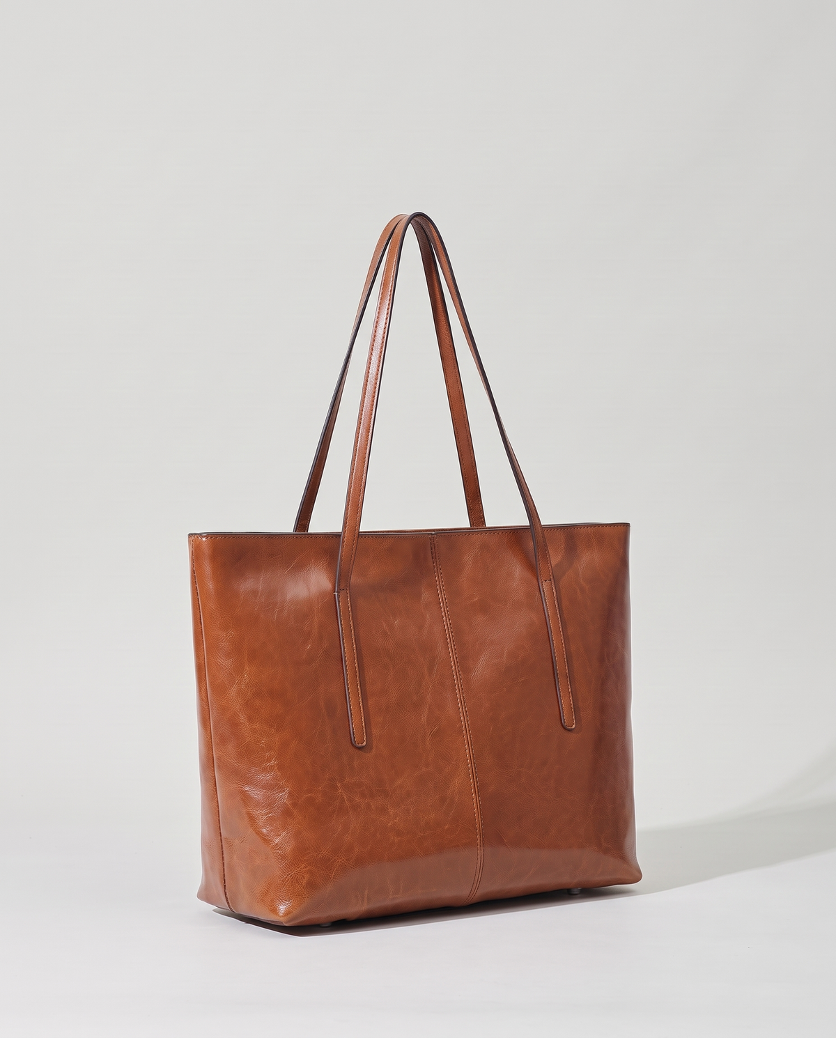 Molo oil-waxed leather tote in cognac, three-quarter view