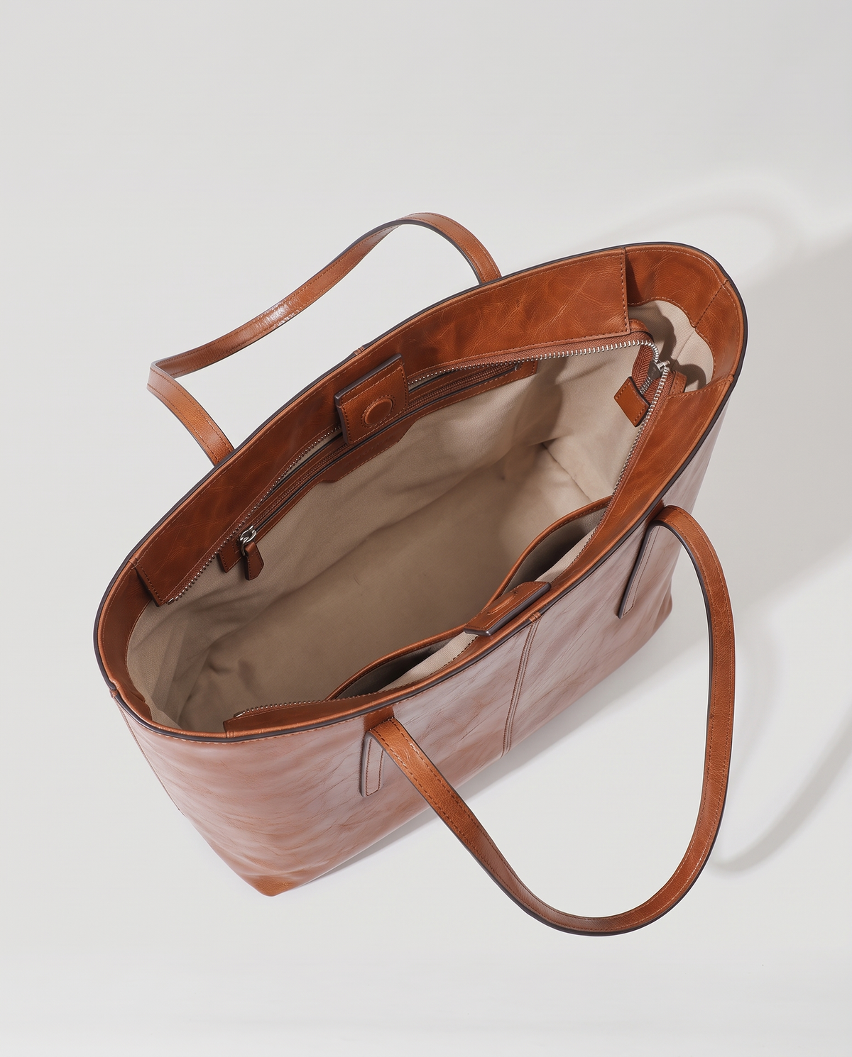 Molo oil-waxed leather tote in cognac, open showing interior