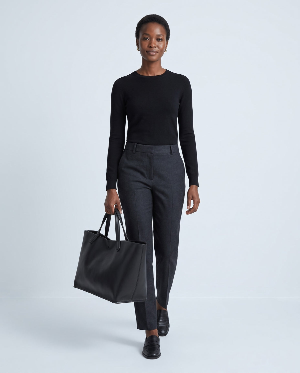 Model carrying the Nube leather tote in Black – full length