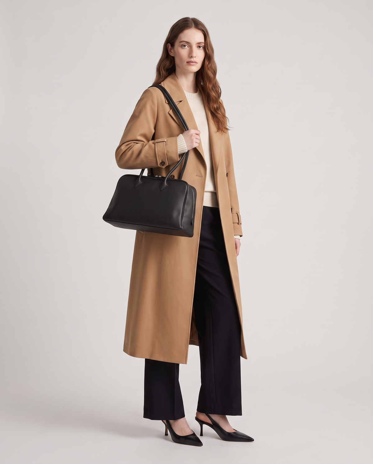 Ora Small leather shoulder bag in Black – model wearing it on her shoulder, full length