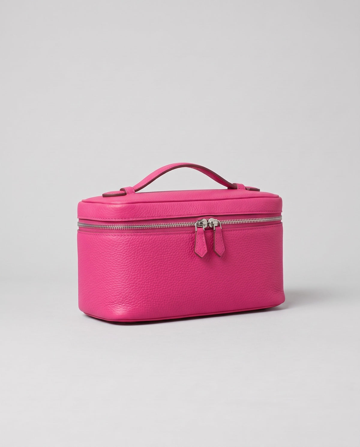 Orvieto pebbled leather vanity case in Fuchsia – three-quarter view