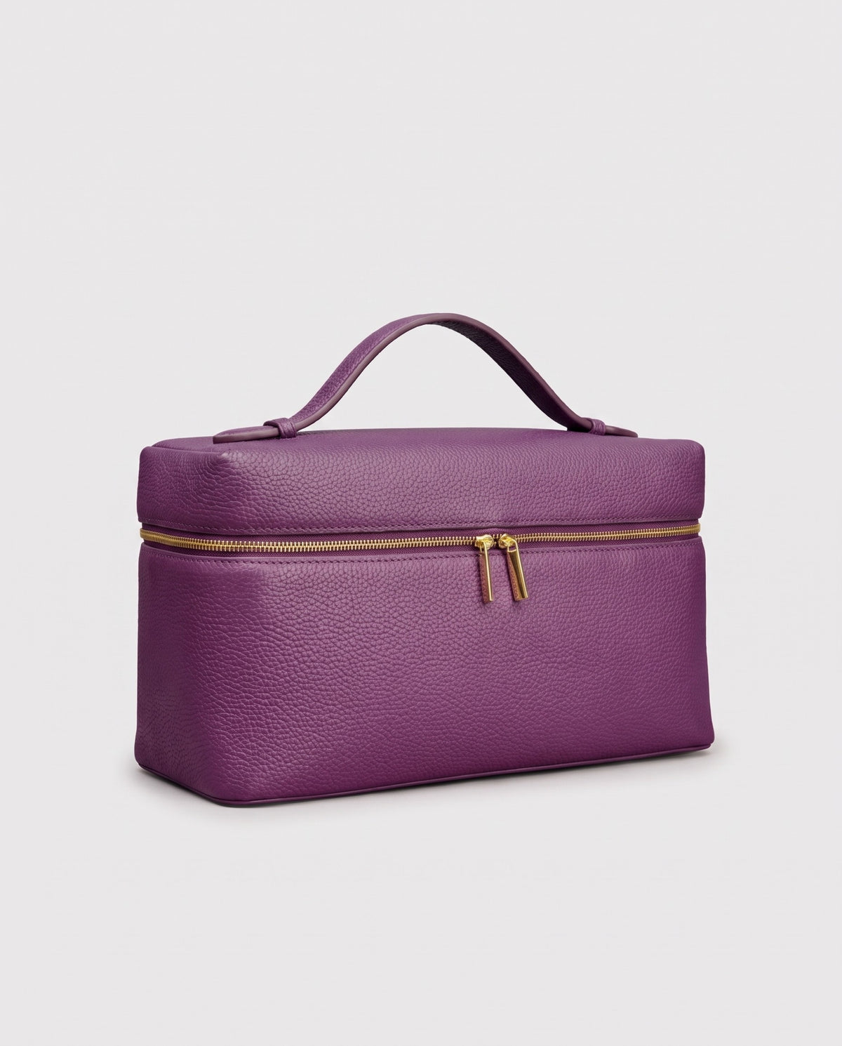 Orvieto pebbled leather vanity case in Purple – three-quarter view