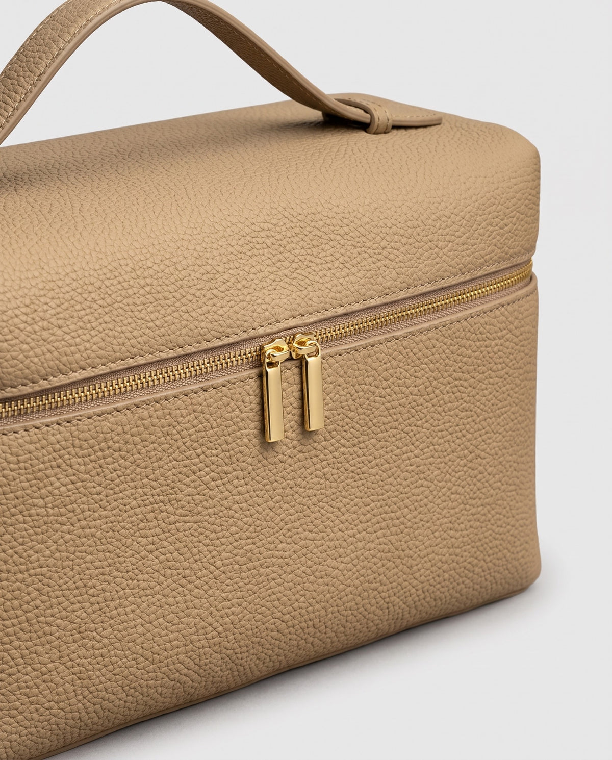 Gold zip detail on the Orvieto vanity case in Stone