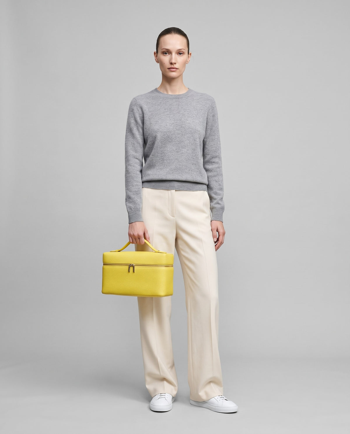 Model holding the Orvieto vanity case in Yellow – full-length view