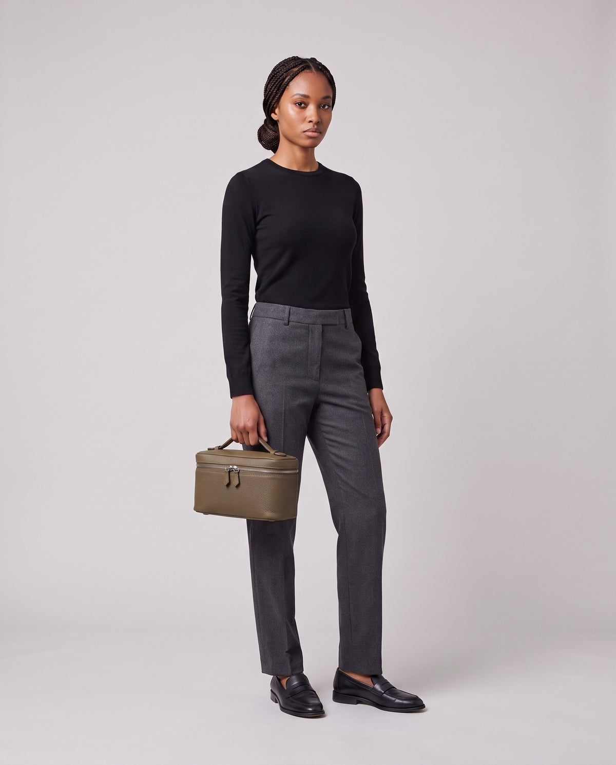 Model holding the Valentina Orvieto Small top-handle bag in Taupe leather, full length