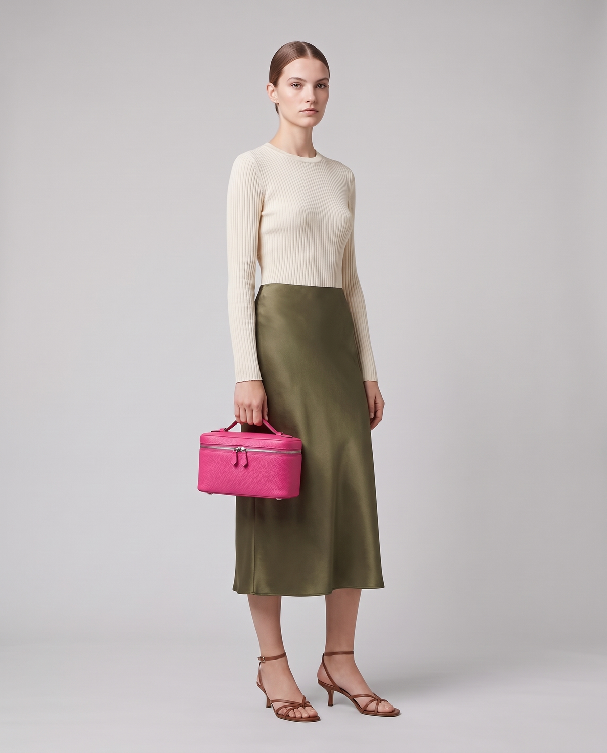 Model carrying the Orvieto vanity case in Fuchsia