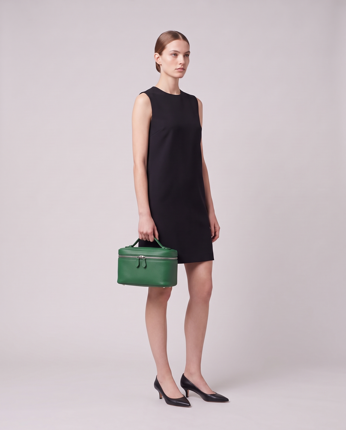 Model carrying the Orvieto vanity case in Green