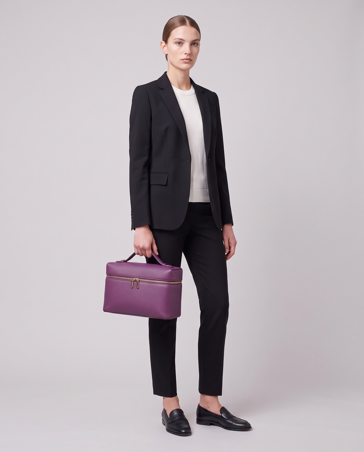 Model carrying the Orvieto vanity case in Purple