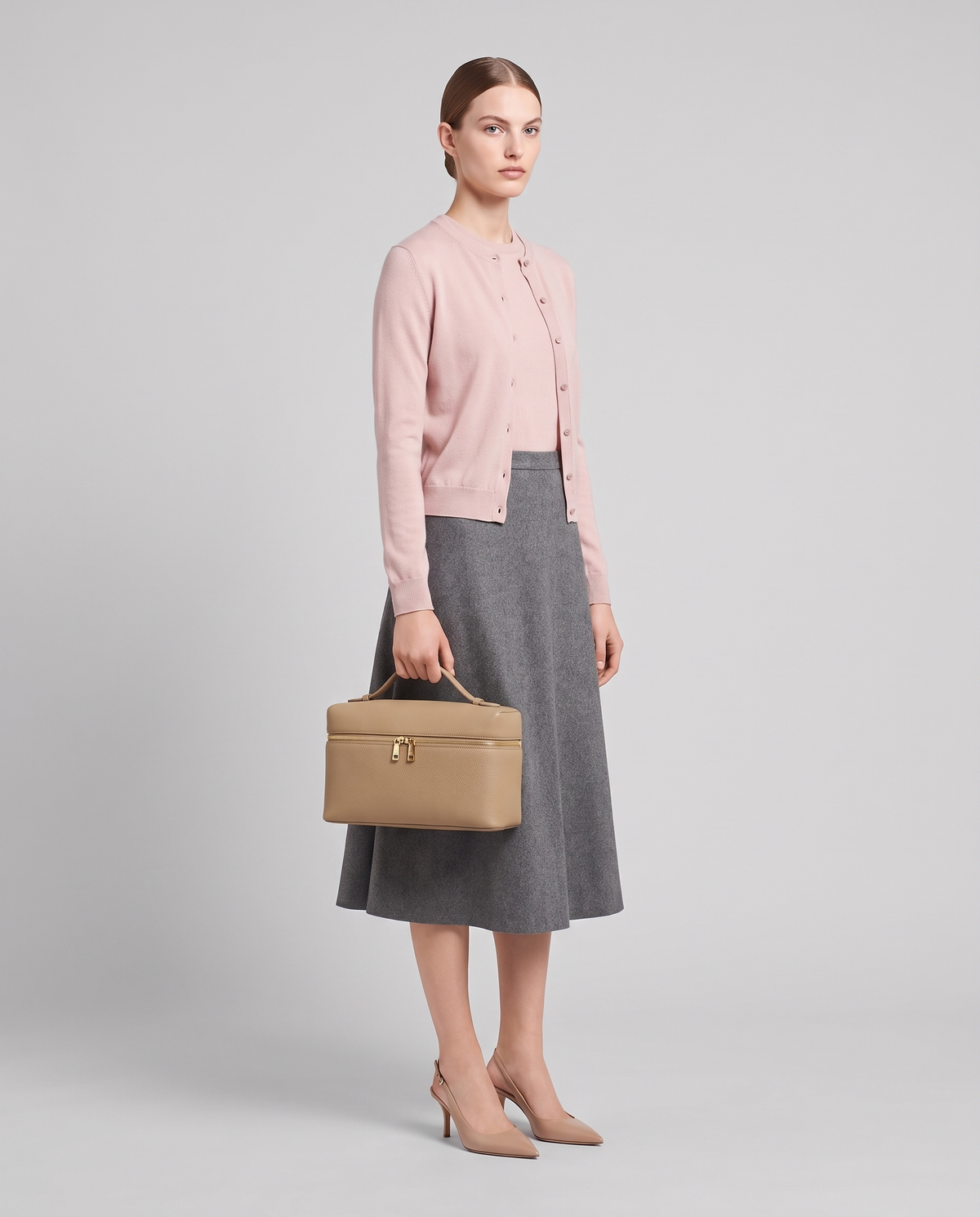 Model carrying the Orvieto vanity case in Stone