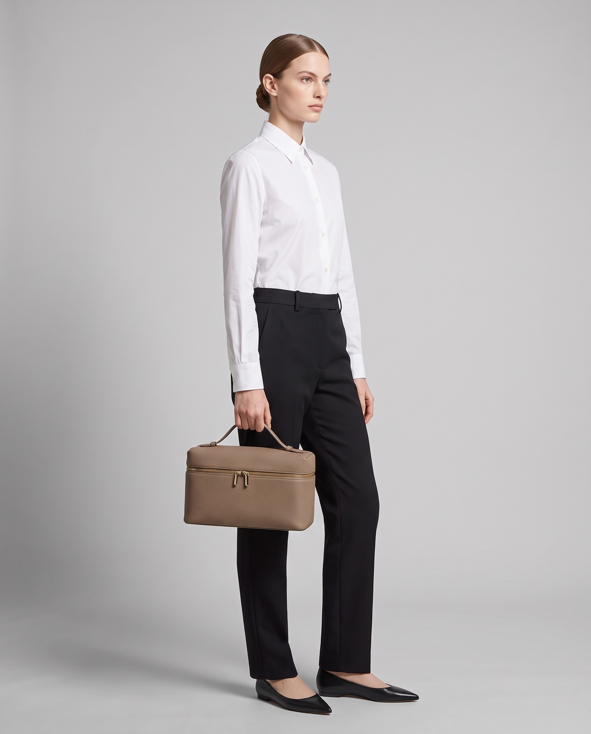 Model carrying the Orvieto vanity case in Taupe