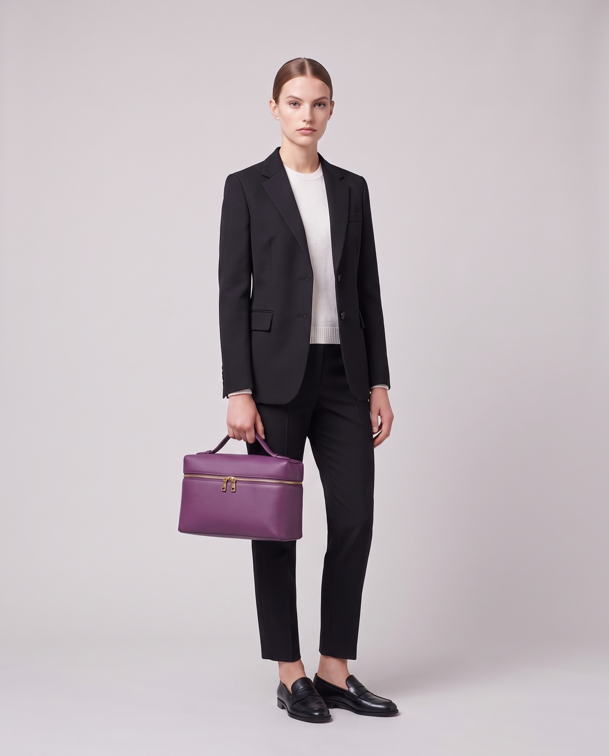 Model holding the Orvieto vanity case in Taupe – full-length view