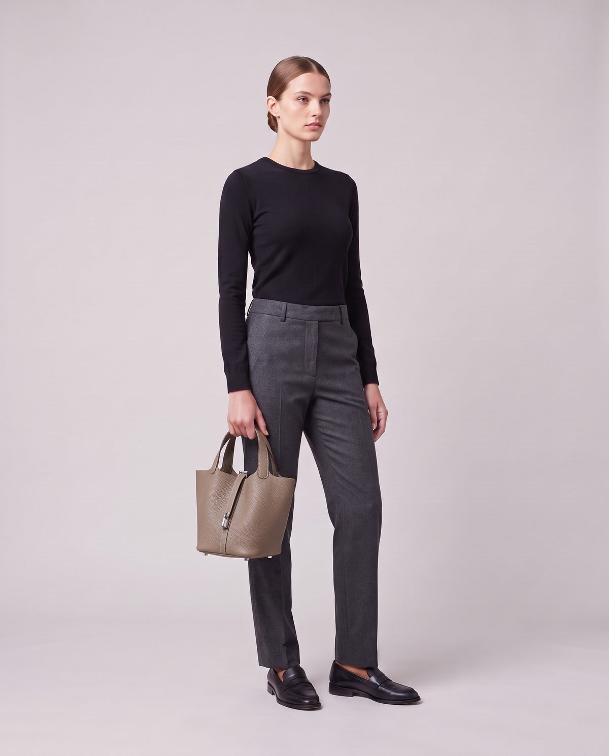 Model holding the Valentina Ostuni Large bag in Stone, full length