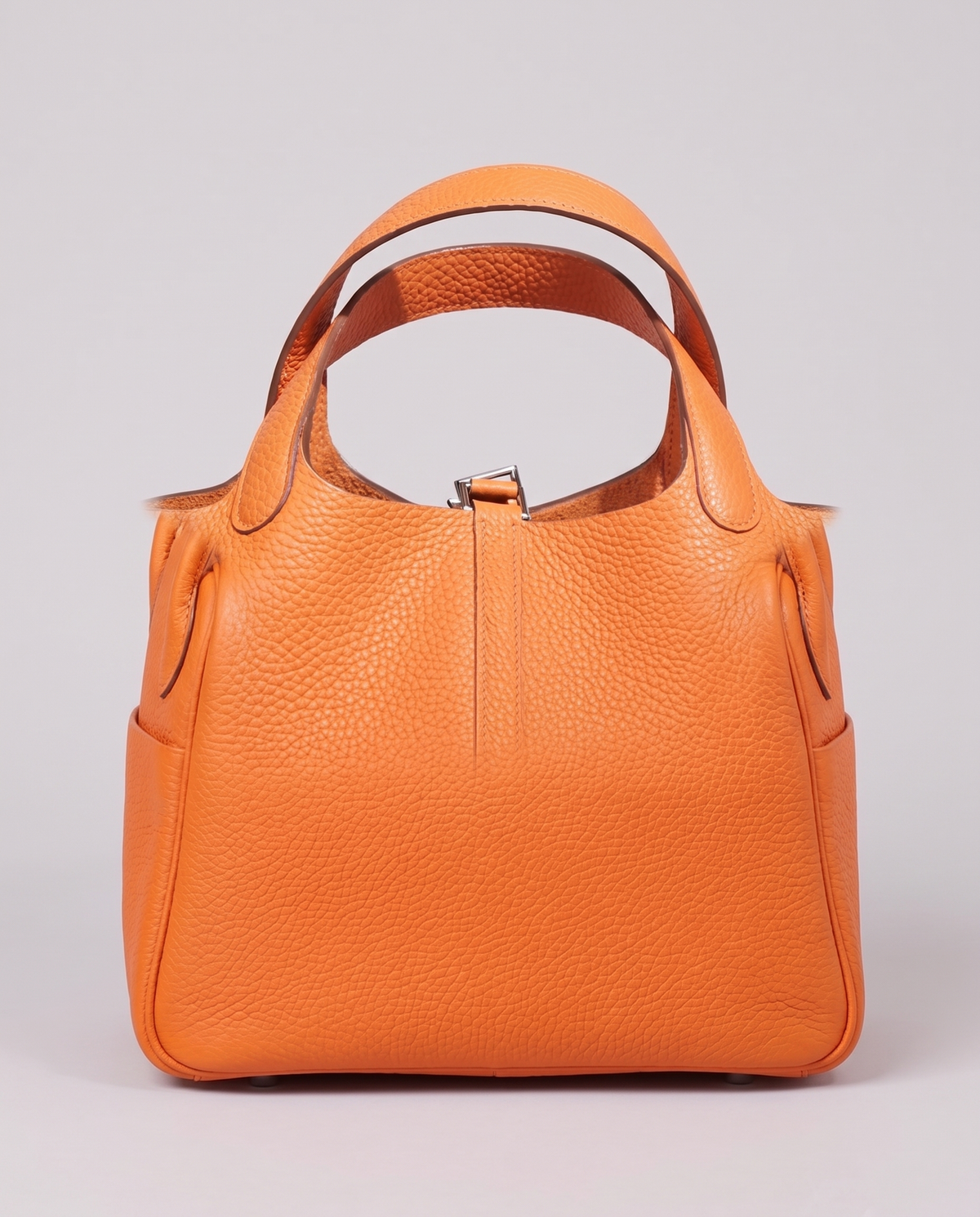 Hardware and handle detail on the Valentina Ostuni Small bag in Apricot