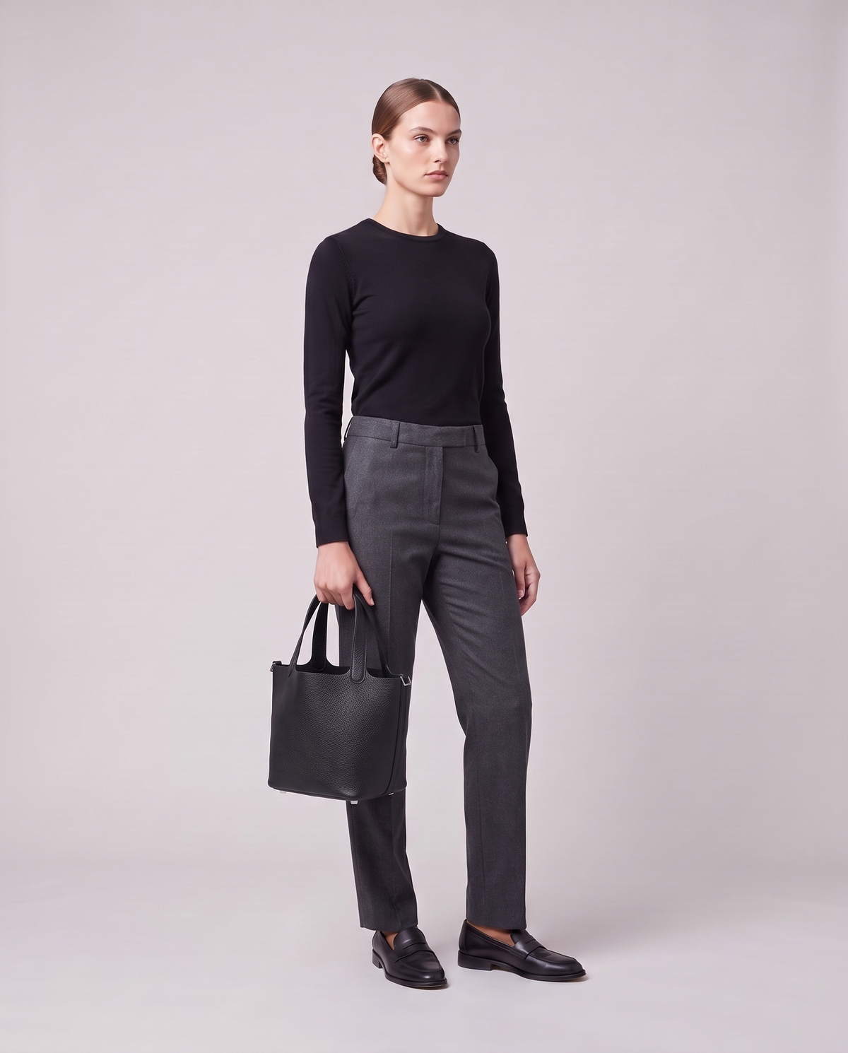 Model holding the Valentina Ostuni Small bag in Black, full length