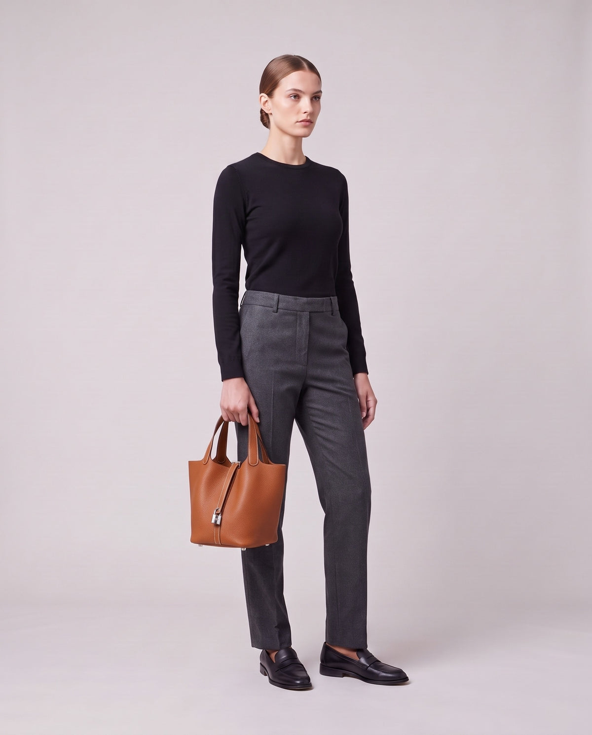 Model holding the Valentina Ostuni Small bag in Cognac, full length