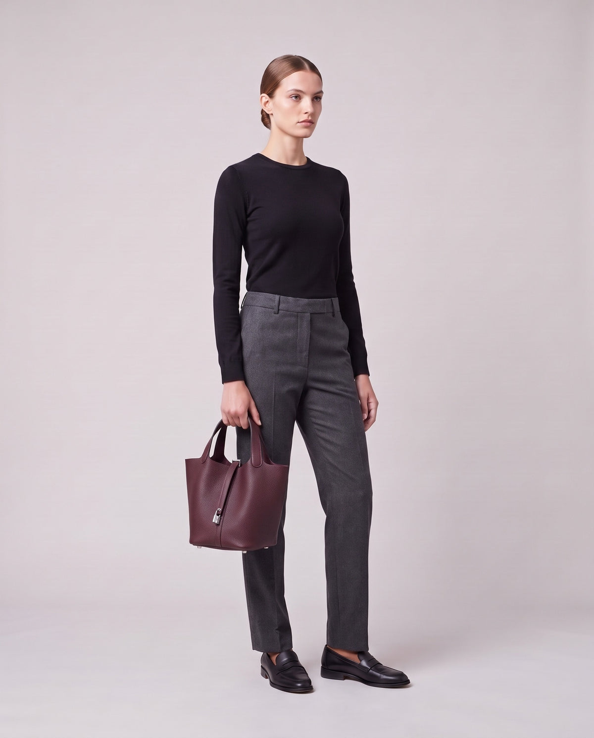 Model holding the Valentina Ostuni Small bag in Plum, full length