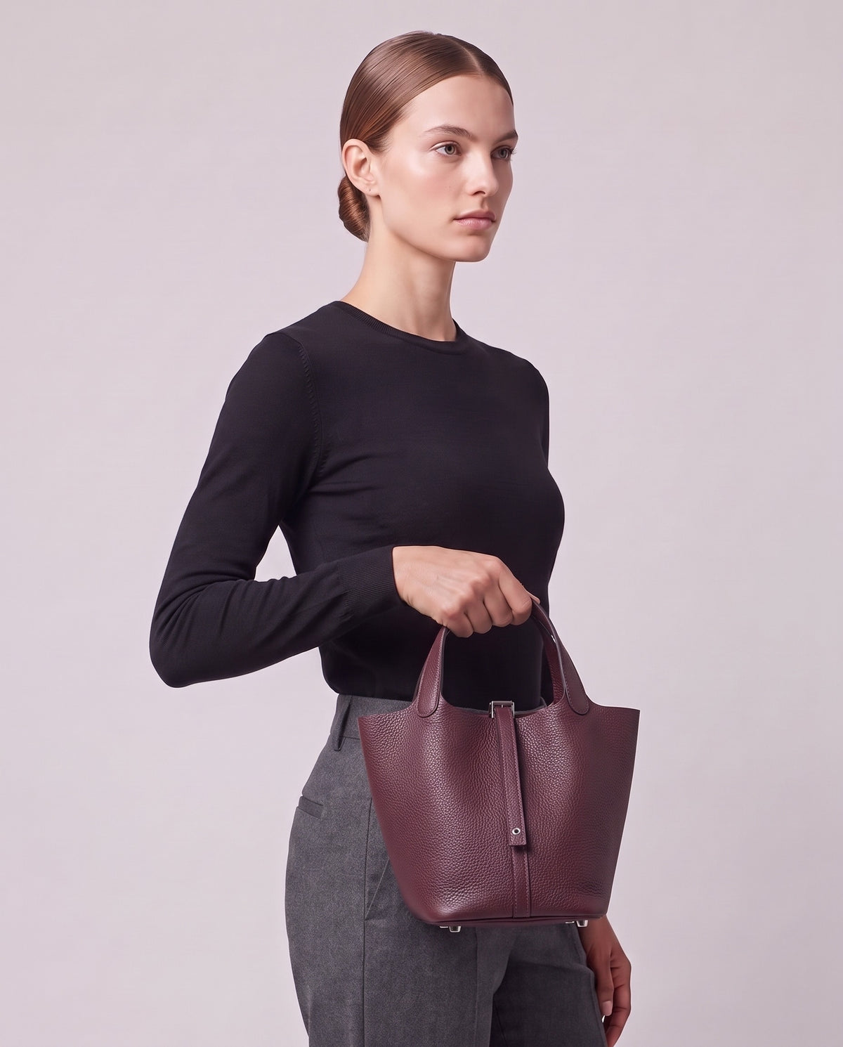 Model carrying the Valentina Ostuni Small bag in Plum