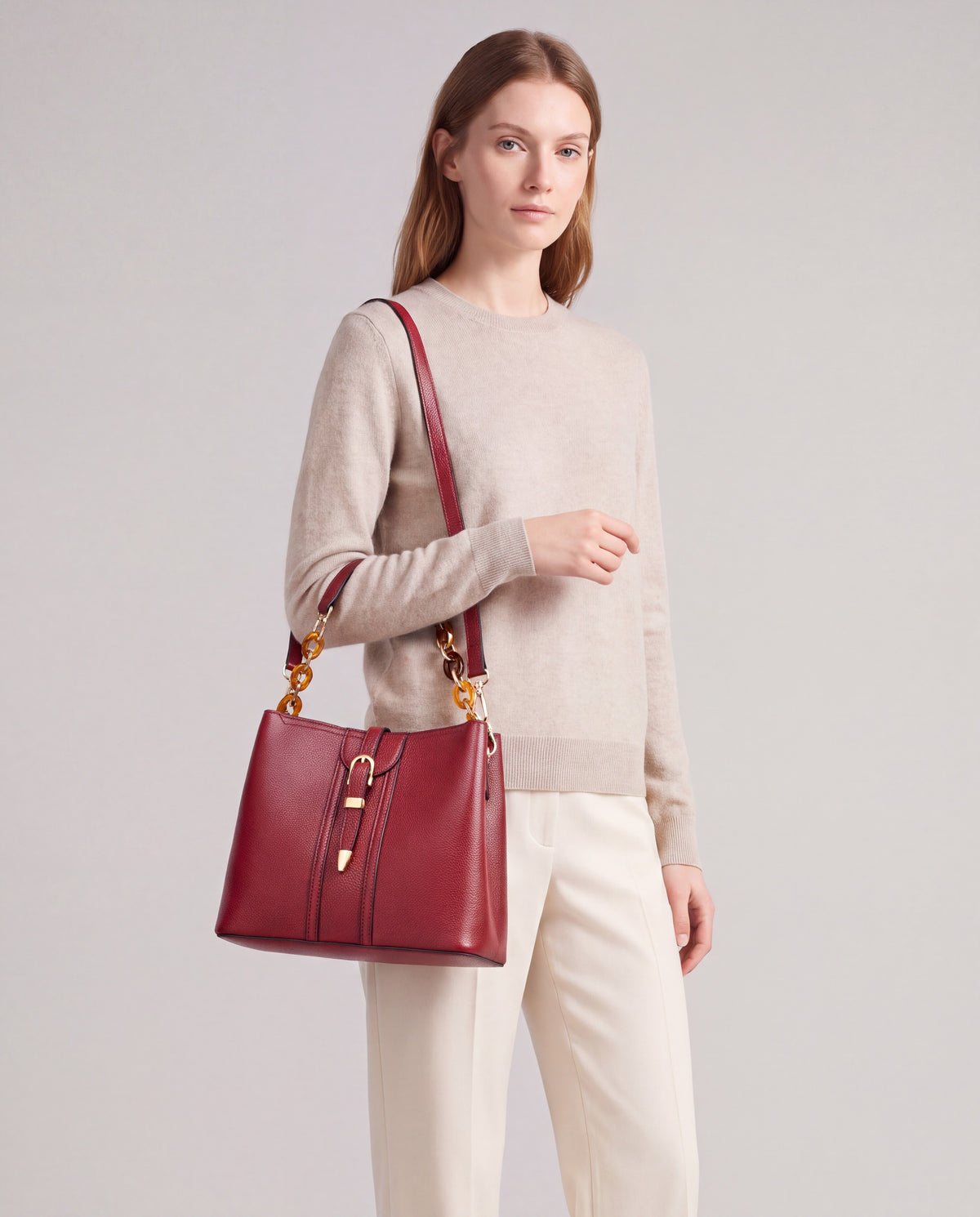 Outline bag in Red – carried by model, close-up