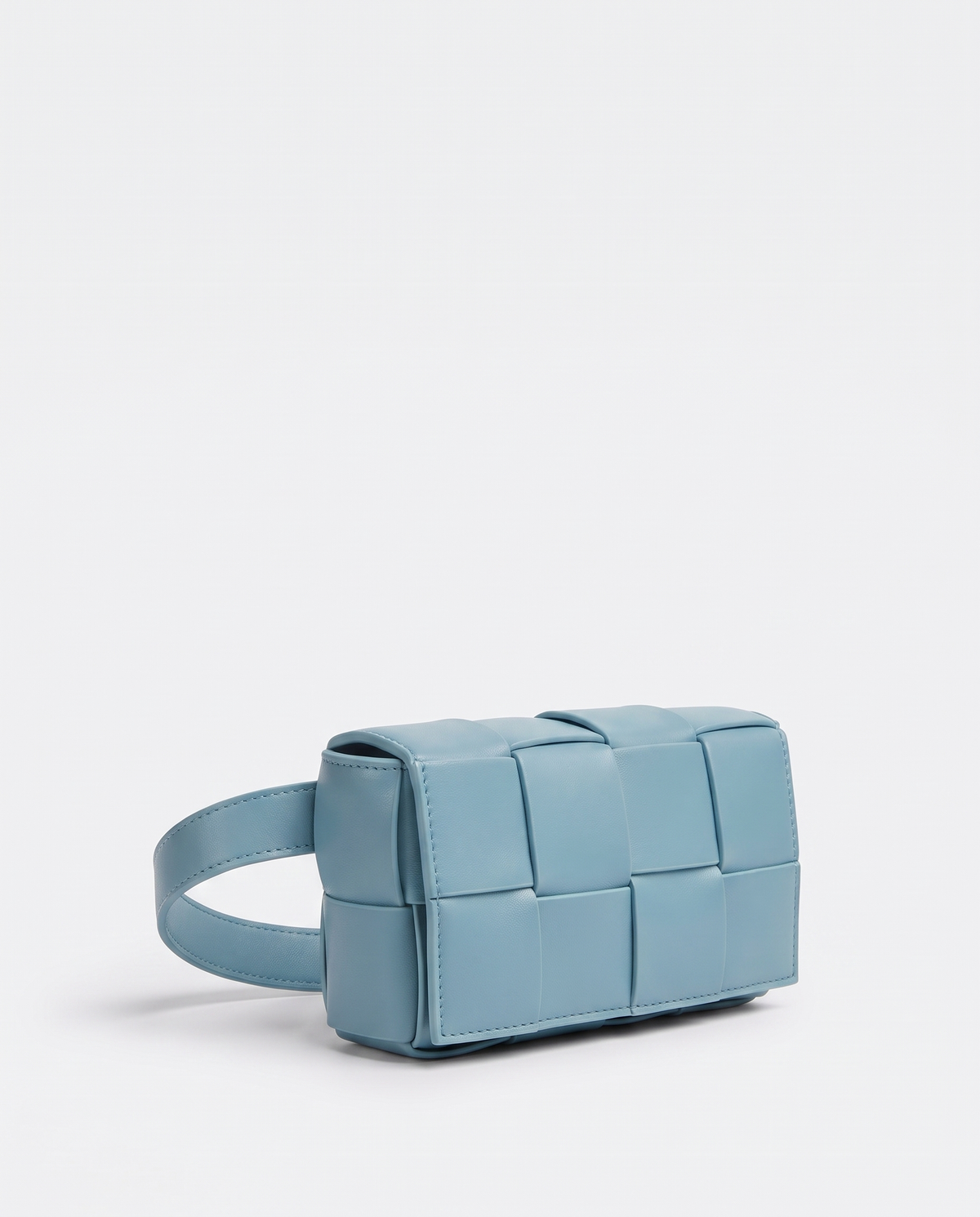 Cassette padded woven leather belt bag in Blue – three-quarter view