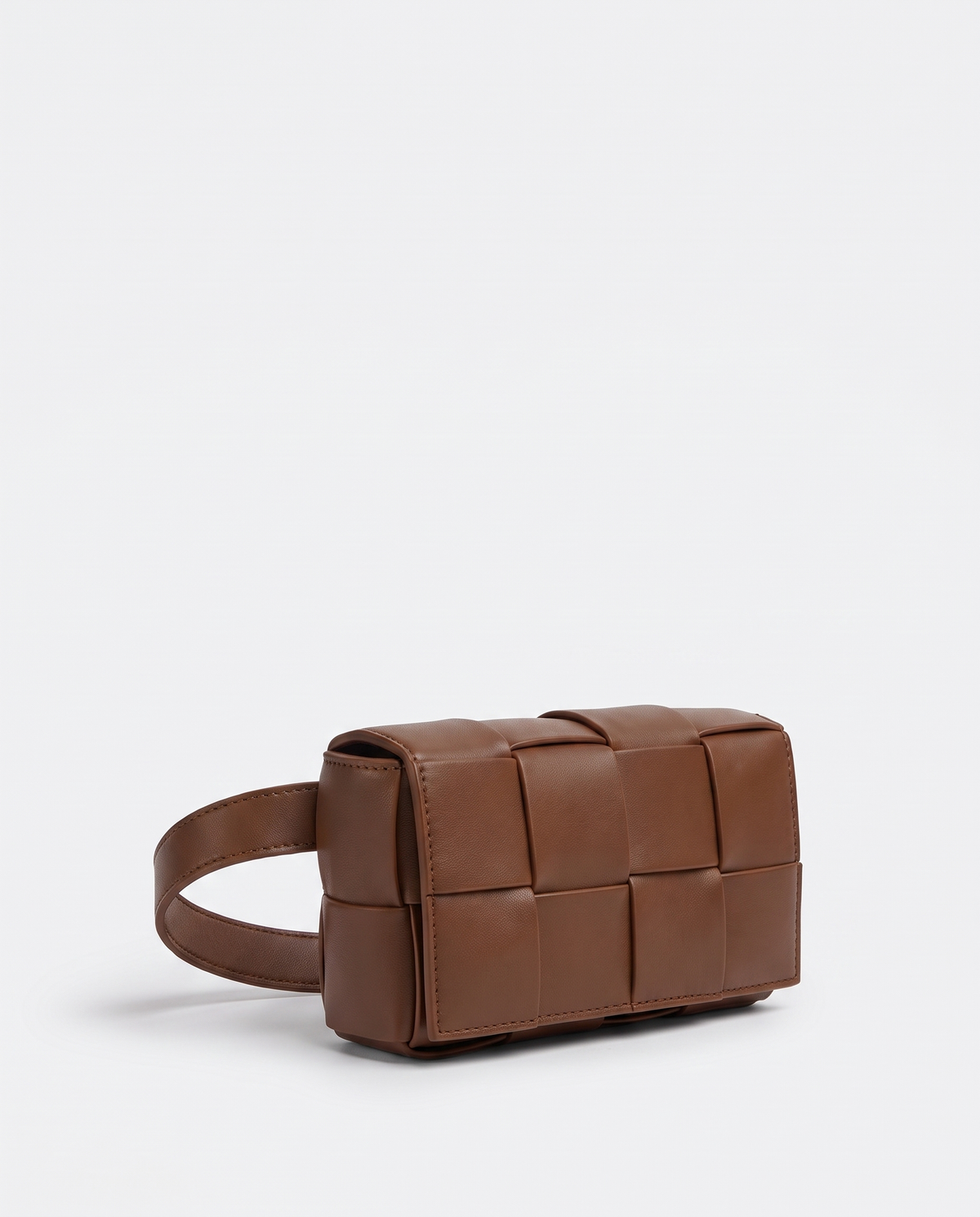 Cassette padded woven leather belt bag in Brown – three-quarter view