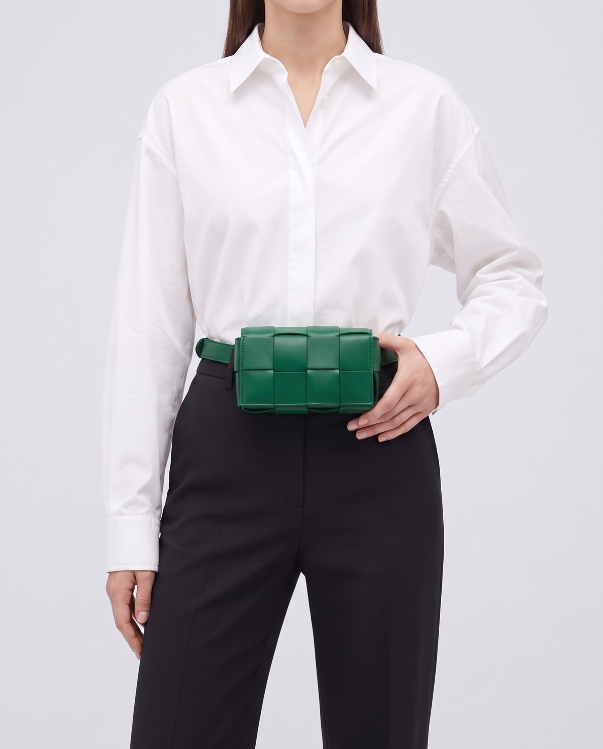 Cassette padded woven leather belt bag in Green – model wearing it at the waist