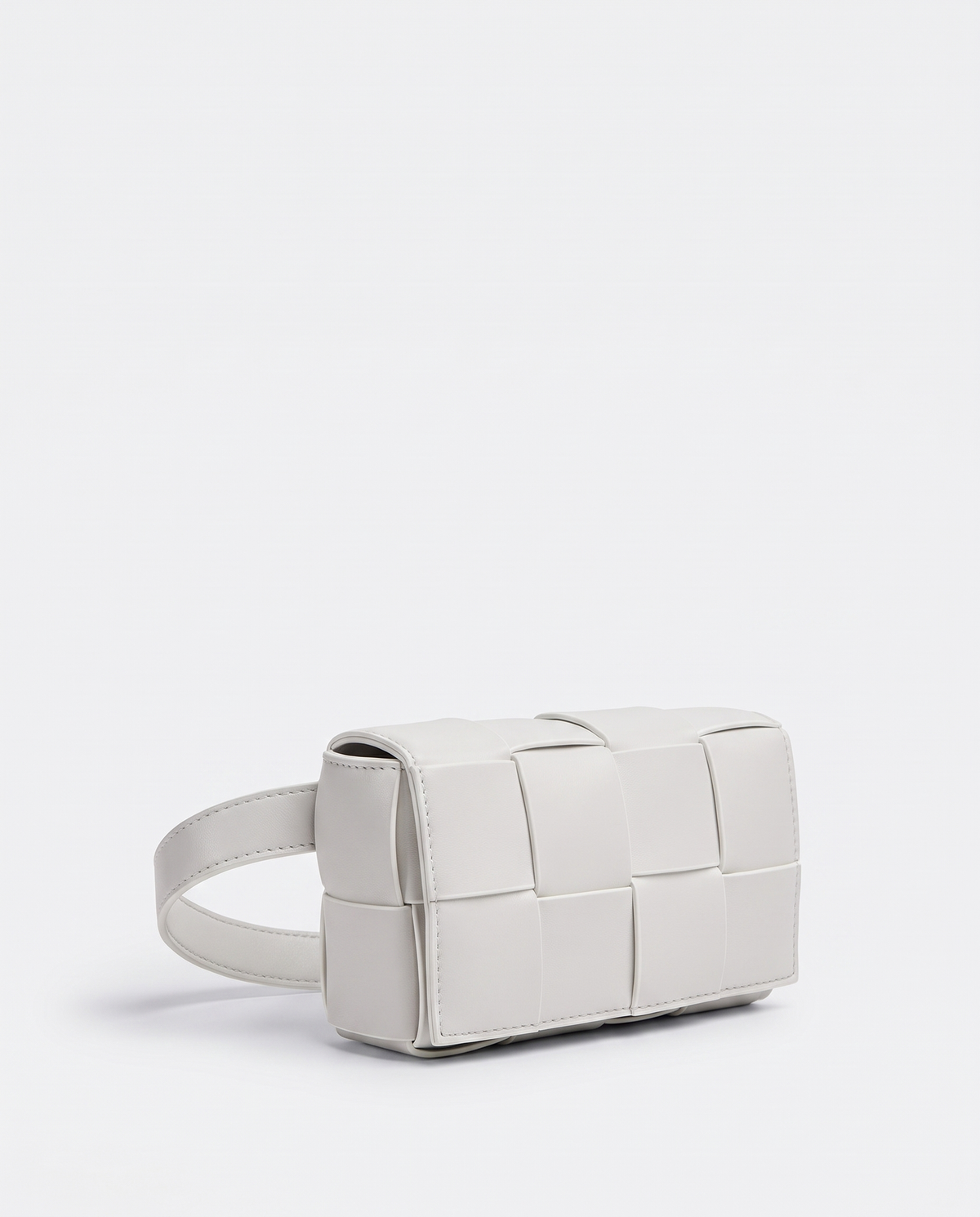 Cassette padded woven leather belt bag in Ivory – three-quarter view