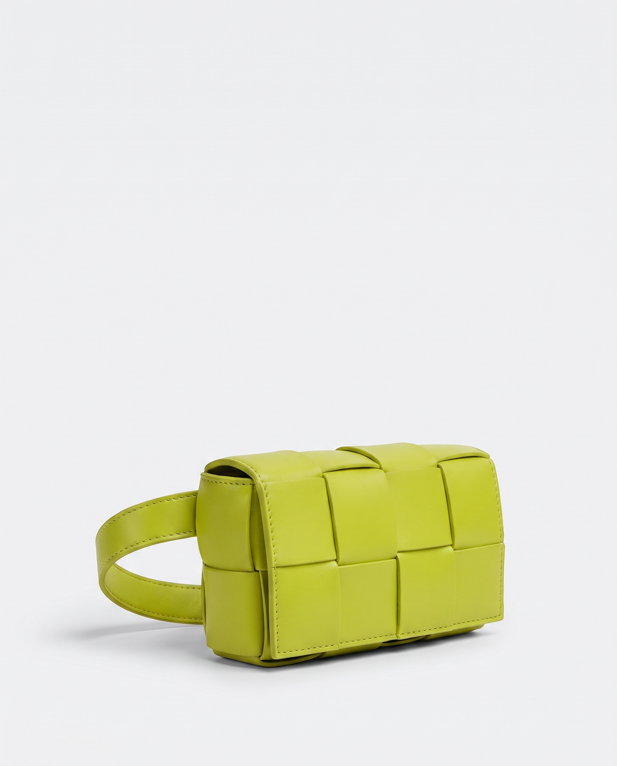 Cassette padded woven leather belt bag in Lime – three-quarter view